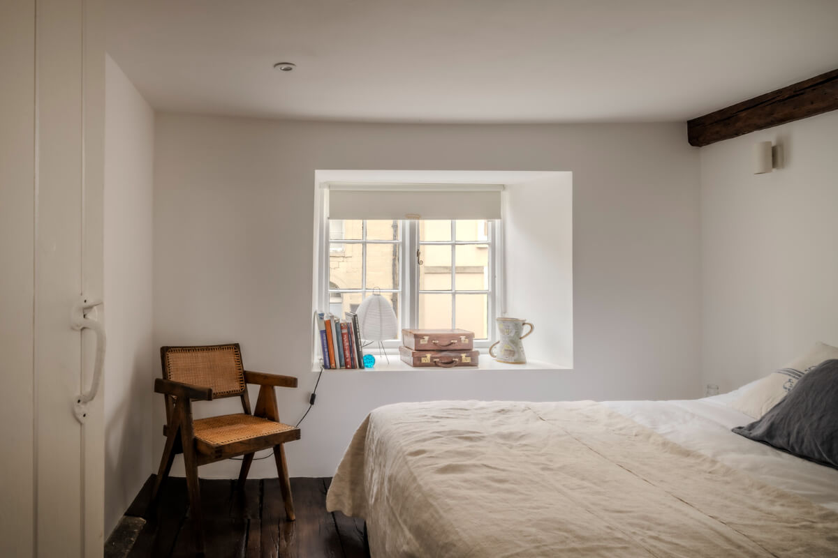 White-Washed Walls and Rustic Elements in a 17th Century Townhouse 20 white bedroom dark wooden floor