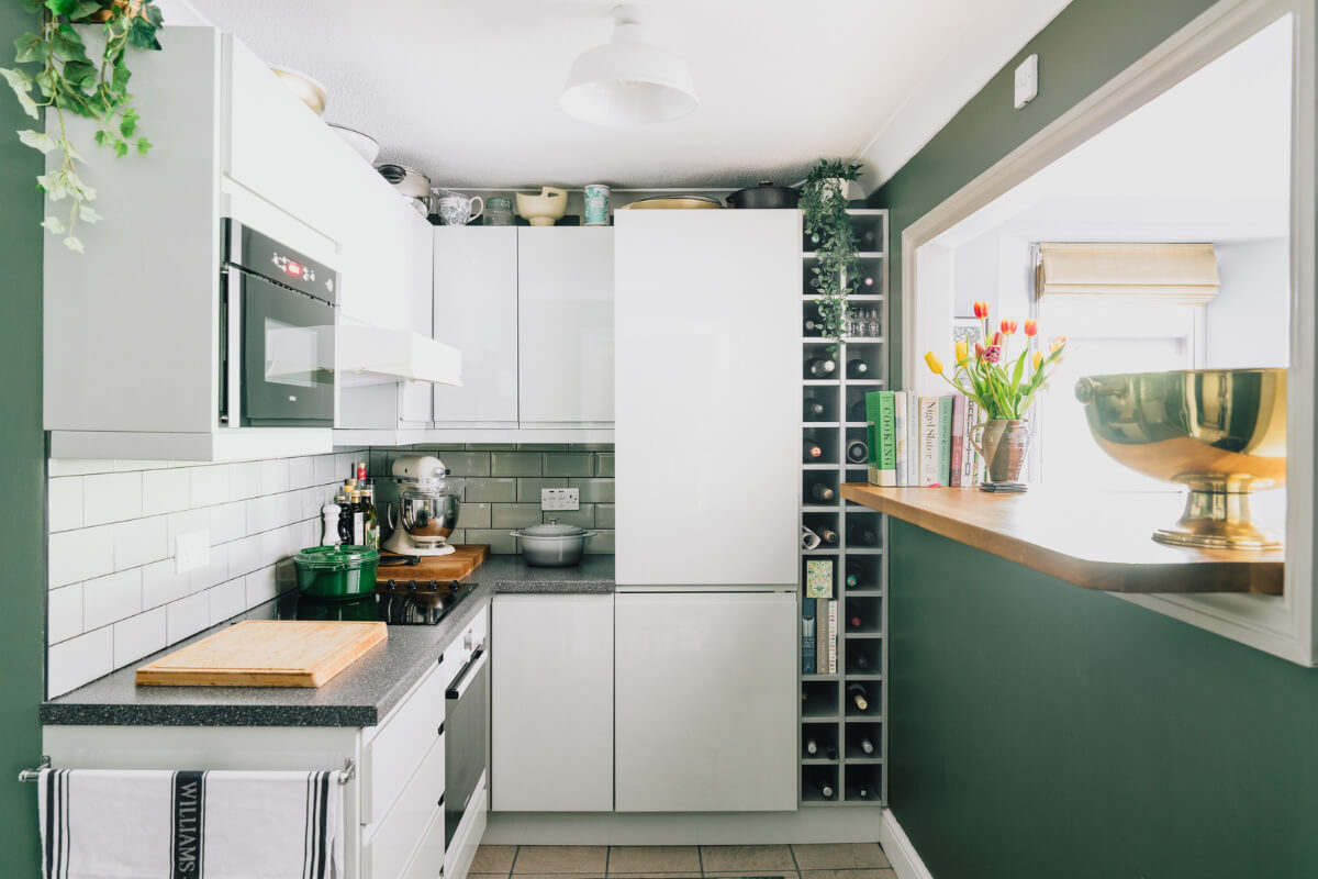 A Colorful Apartment in a Former Victorian Church in London 5 white kitchen cabinets green walls