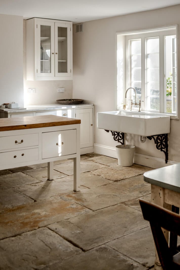 Grand, Light-Filled Spaces in a Gothic-Style English Coastal Home 25 white kitchen flagstone floor