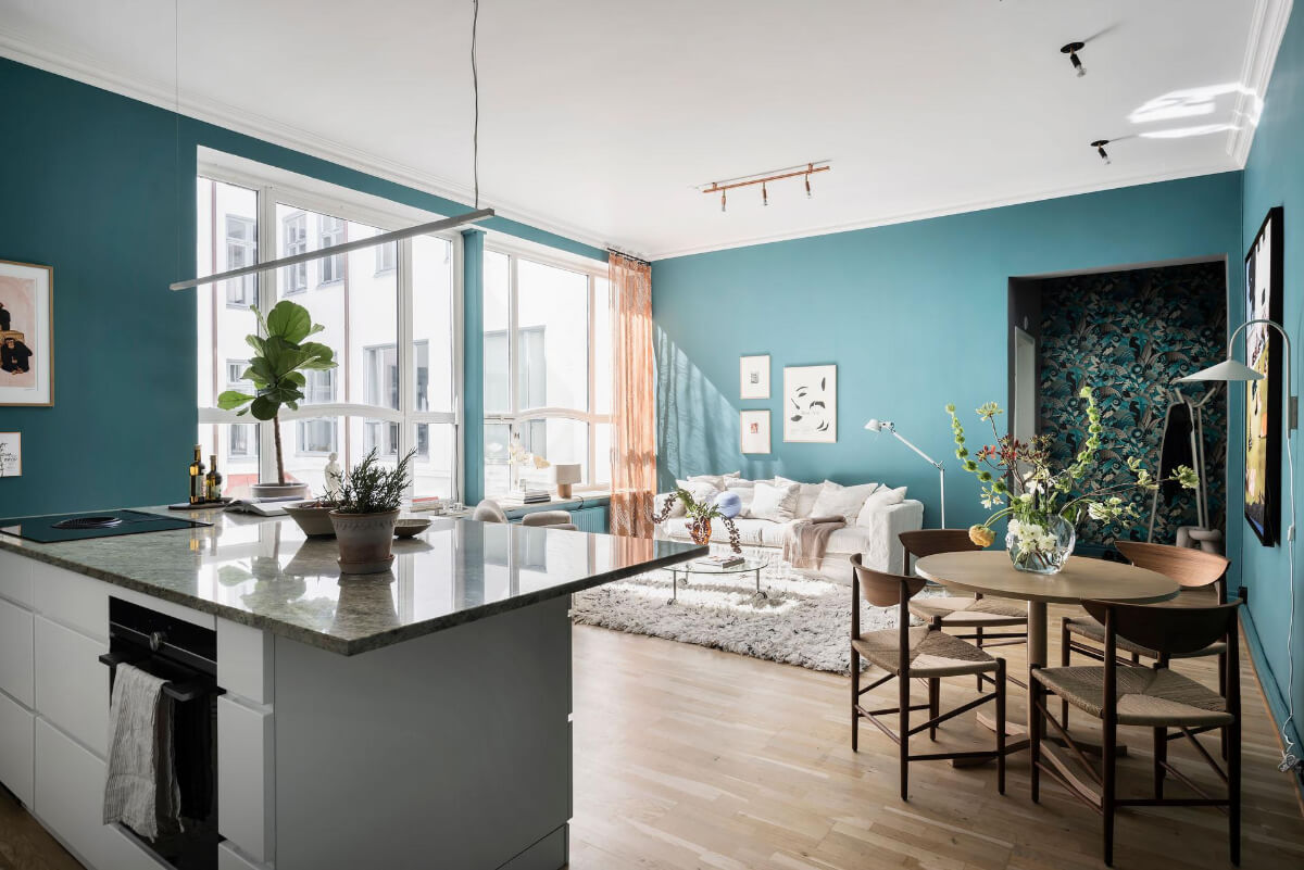 A Teal Green Living Room and Large Windows in a Swedish Apartment 13 white kitchen open living area round dining table