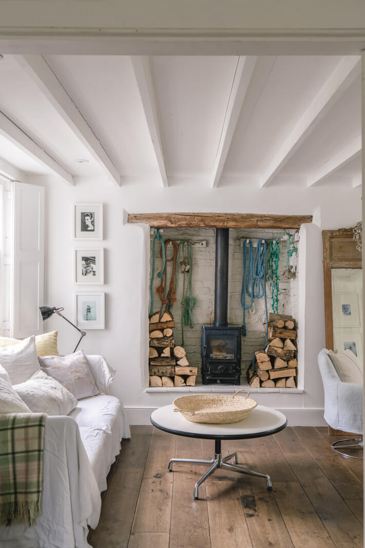 A Bright New England-Style Home with a Lush Garden 5 white living room wood burner