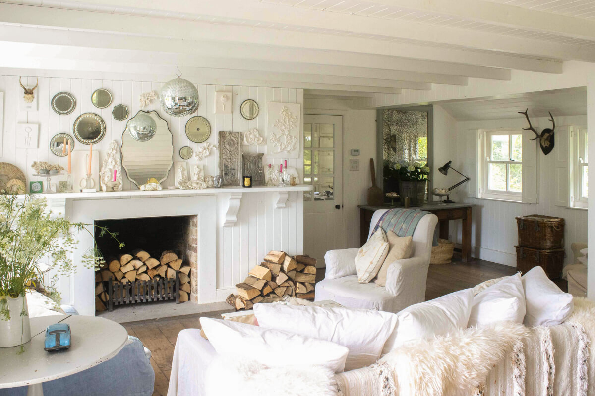A Bright New England-Style Home with a Lush Garden 6 white living room wooden ceiling fireplace