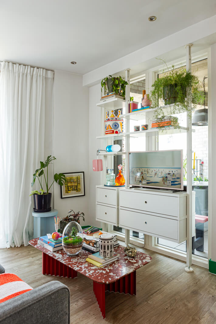 Playful Colors in a Modern One-Bedroom Apartment in London 4 white shelving sysyem