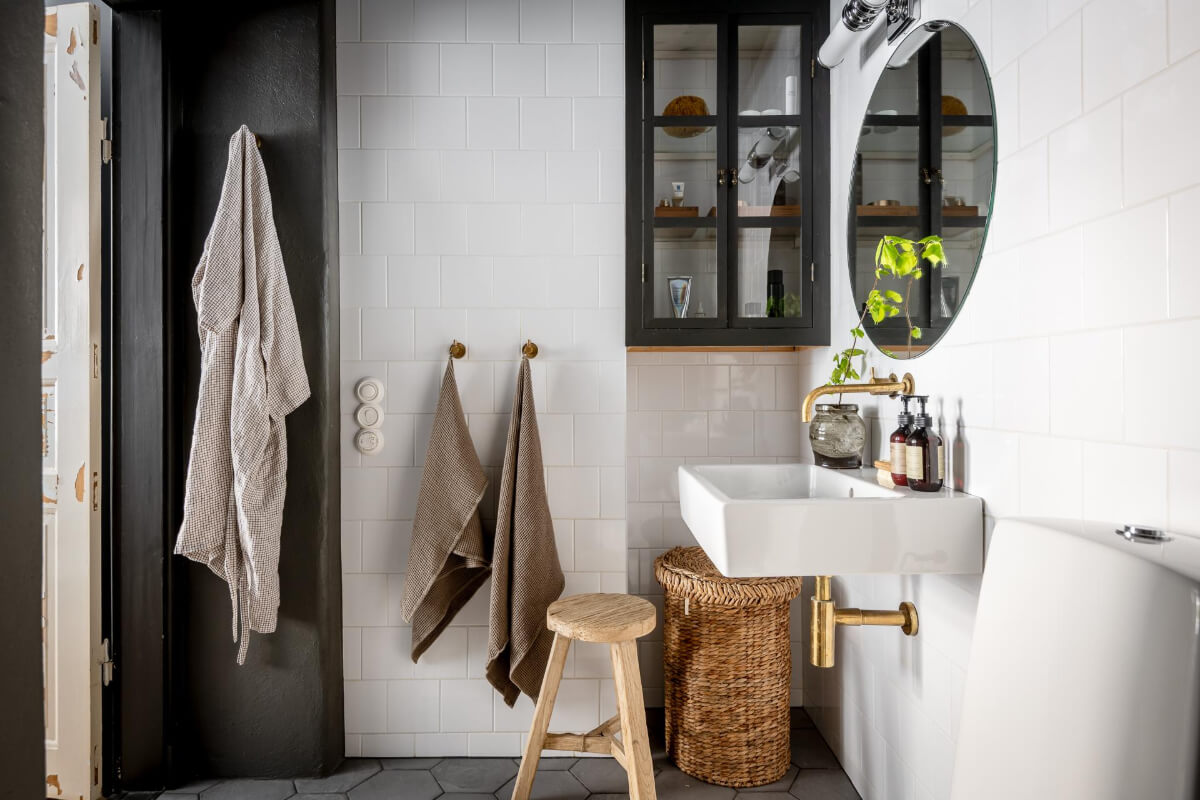 A Blue Studio Apartment with Unique Stucco and Site-Built Storage 17 white tiled bathroom glass cabinet