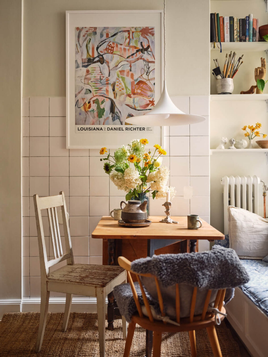 A Cozy, Tiny Apartment with a Golden Yellow Bedroom 3 white tiled wall wooden folding table