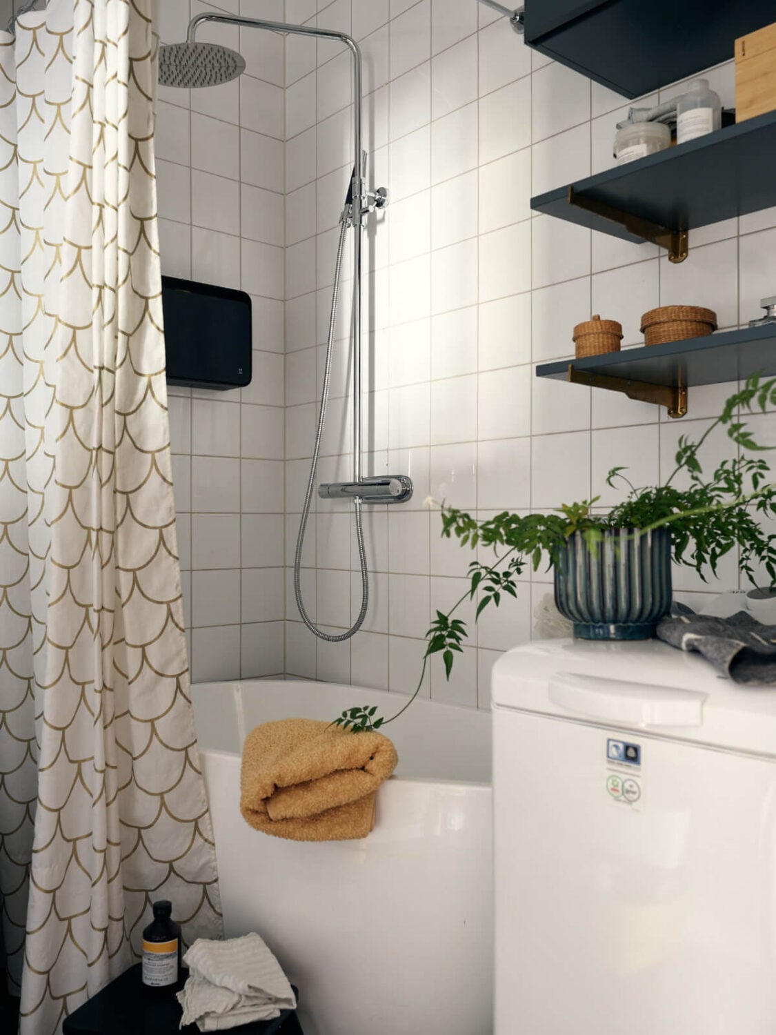 A Stunning Top-Floor Apartment with High Ceilings in a Former Church 29 white tiles bathroom with bath blue shelves