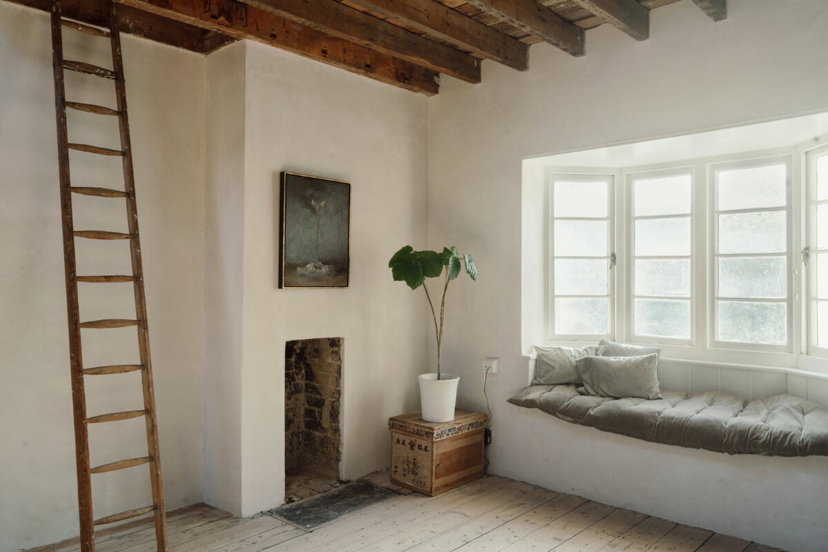 Grand, Light-Filled Spaces in a Gothic-Style English Coastal Home 13 window seat exposed timber ceiling