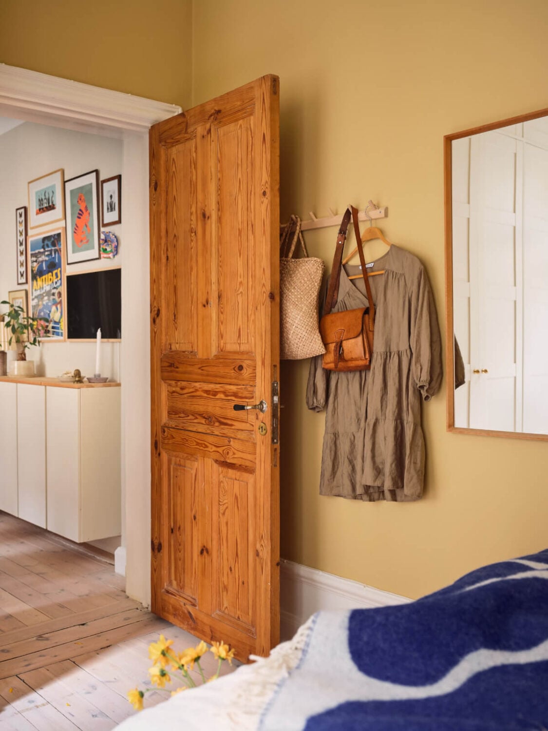 A Cozy, Tiny Apartment with a Golden Yellow Bedroom 16 wooden bedroom door
