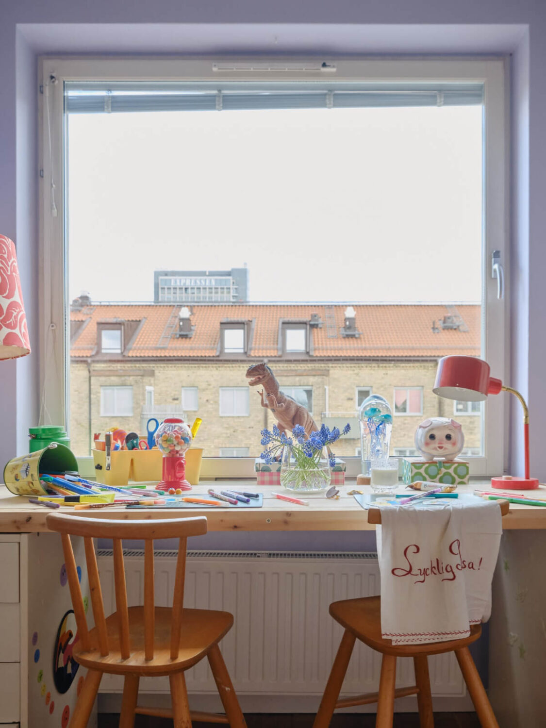 A Colorful 1940s Apartment with Original Elements 22 wooden desk in front of large window