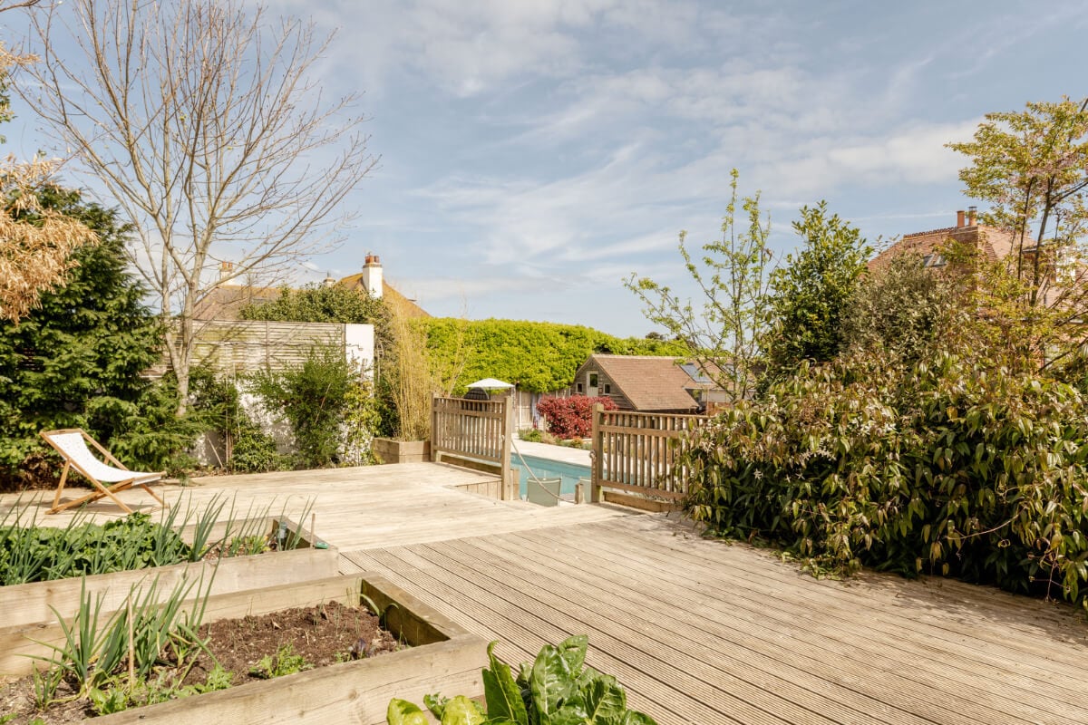 A Grand Edwardian Villa with a Yellow Kitchen and Coastal Views 34 wooden lounge deck garden