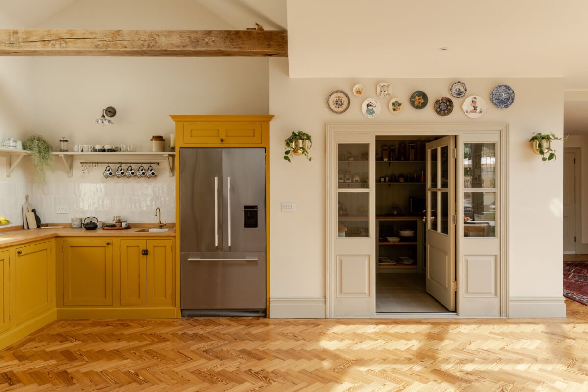 A Grand Edwardian Villa with a Yellow Kitchen and Coastal Views 7 yellow kitchen cabinets herringbone floor