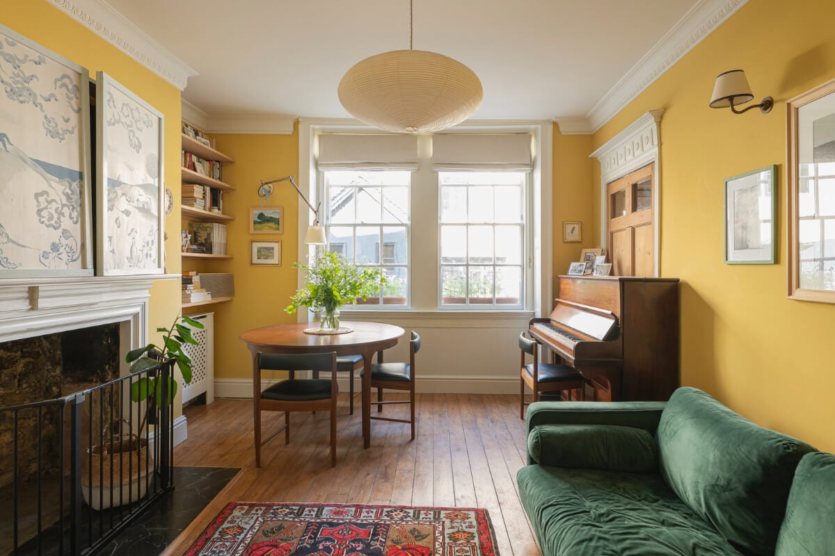 A Family Home with a Cheerful Color Palette in a Historic House 1 yellow living room fireplace stucco