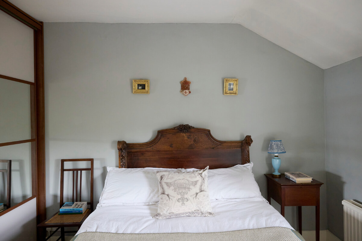 Cozy Living Spaces and Limewash Walls in an Artist's English Home 20 antique bedframe