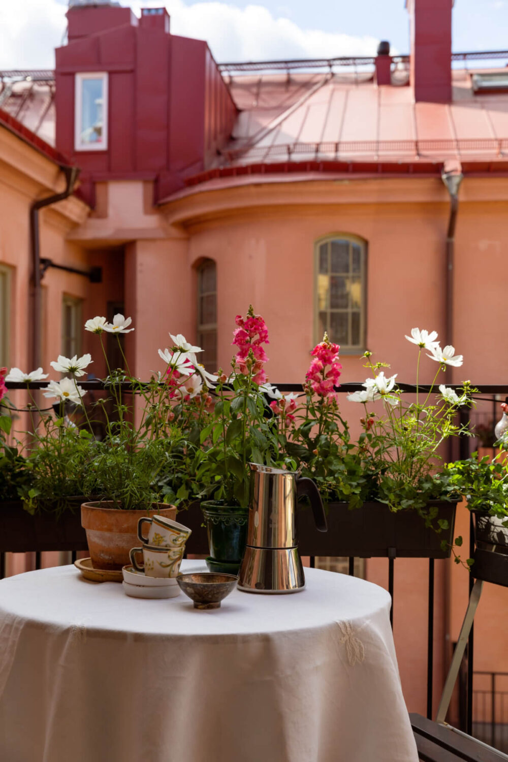 Antiques and Modern Additions in a Cozy Top Floor Duplex Apartment 10 balcony table flowers