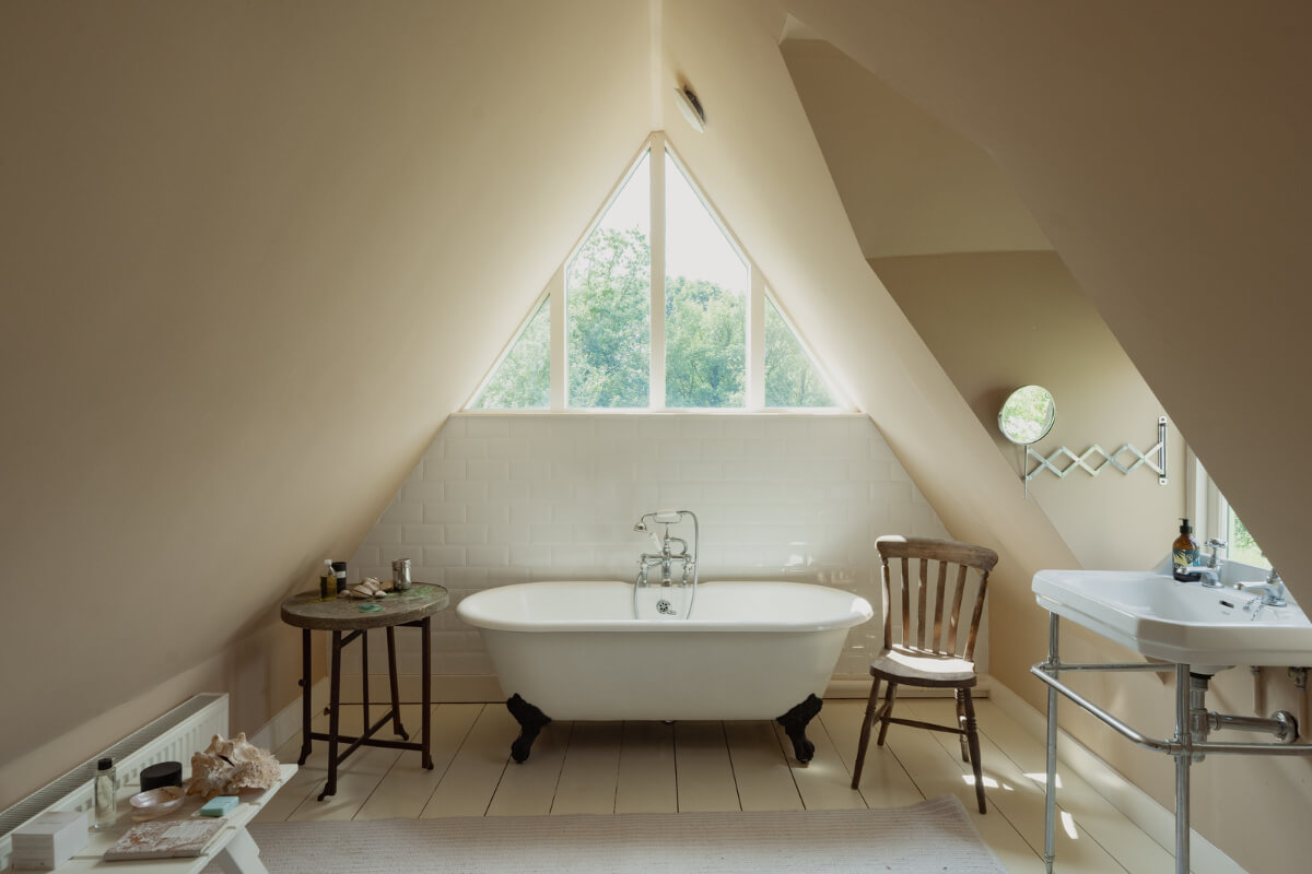 Colorful Interiors and Period Features in a 16th-Century Farmhouse 21 bathroom freestanding bath white painted floorboard slanted ceiling