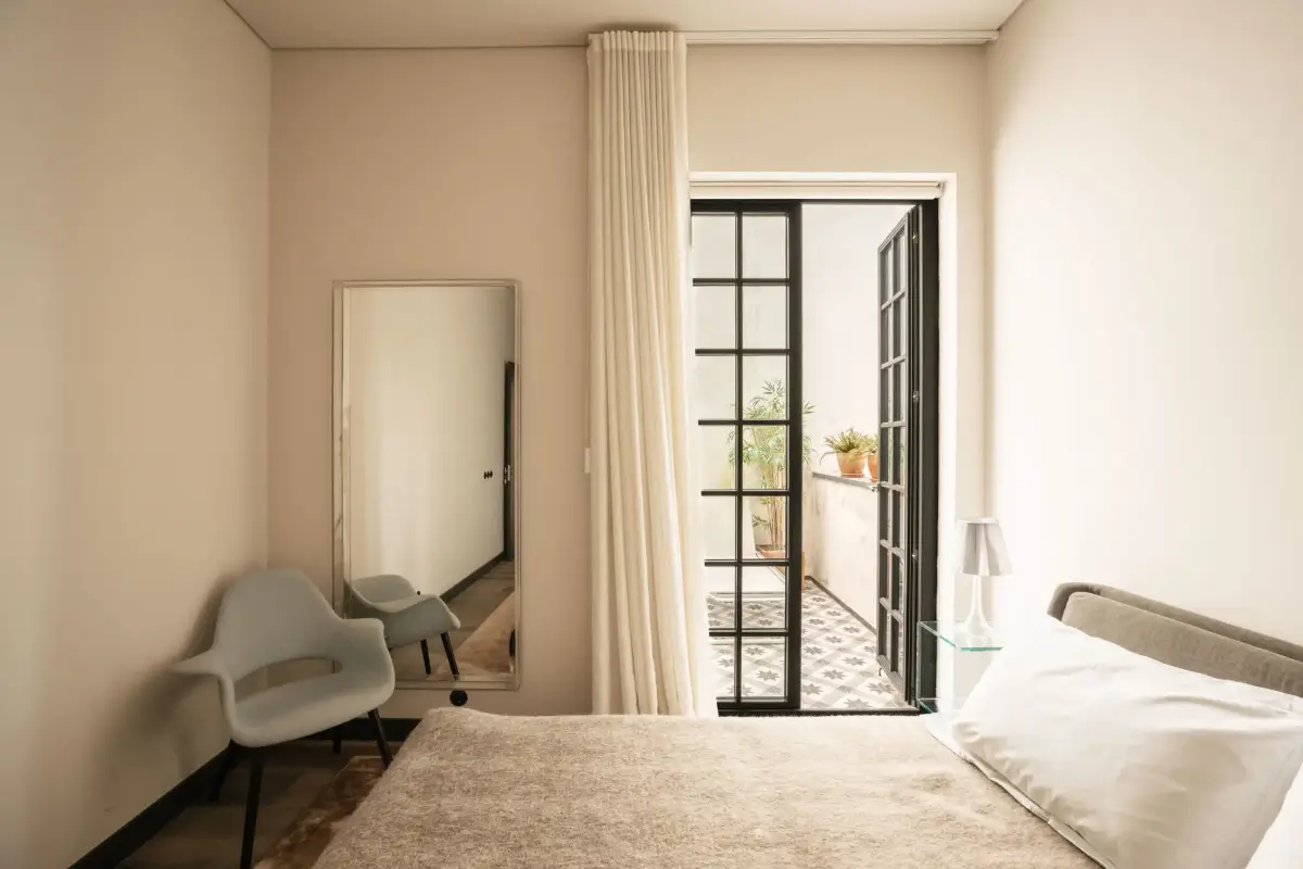 An Eye-Catching Stone Wall in a Beautiful Lisbon Apartment 9 bedroom glass doors to terrace