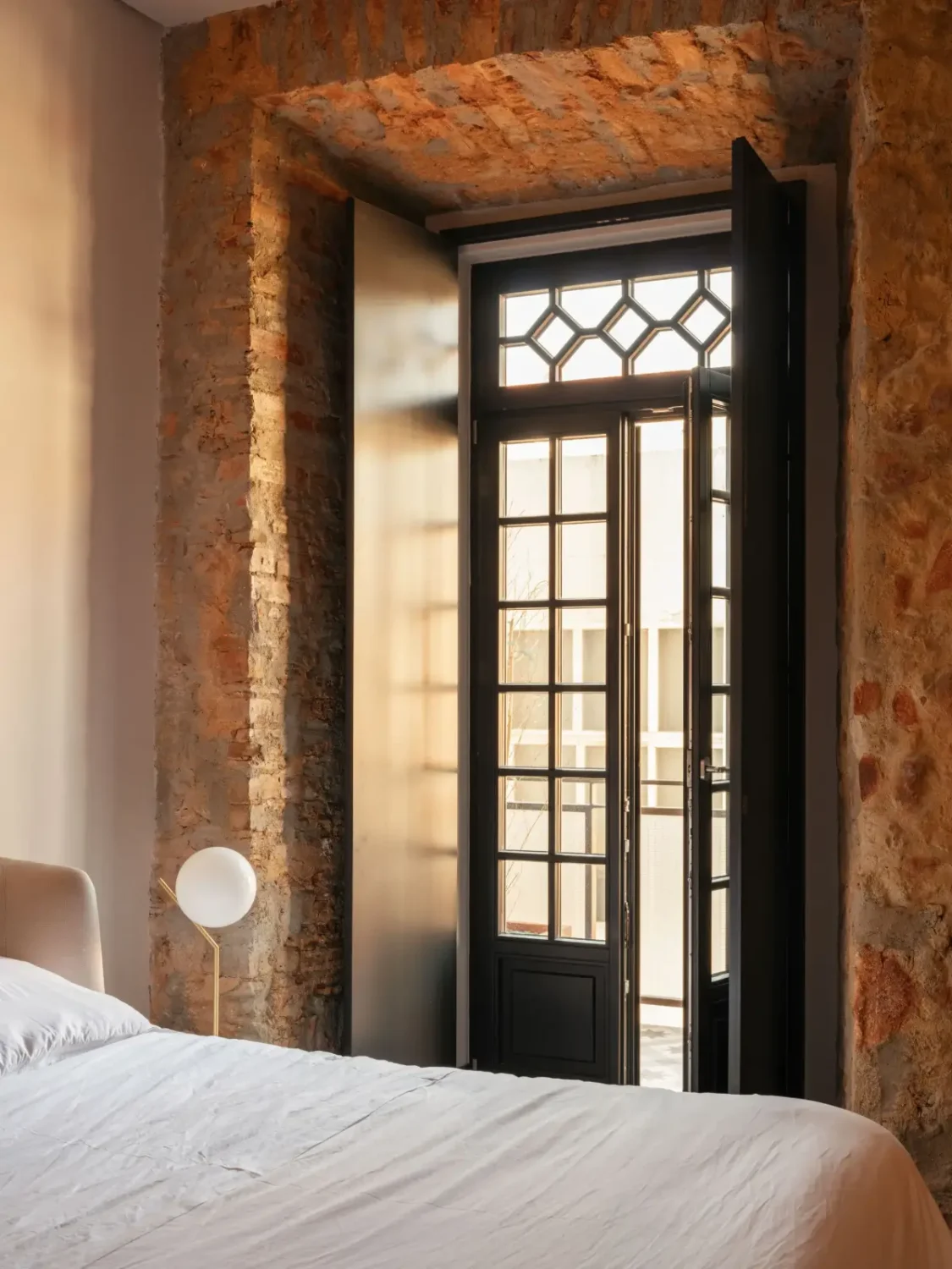 An Eye-Catching Stone Wall in a Beautiful Lisbon Apartment 7 bedroom stone walls french doors