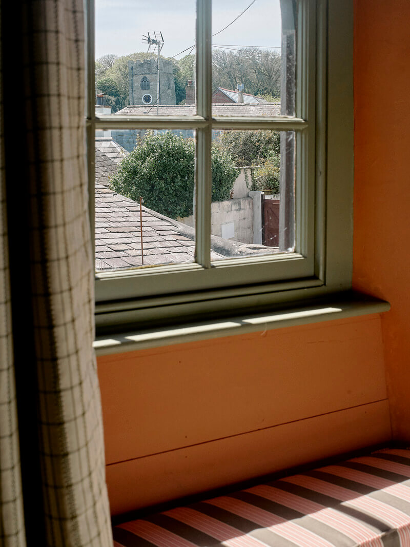 Bespoke Interiors and an Earthy Color Palette in a Historic Cottage 17 bedroom window bench
