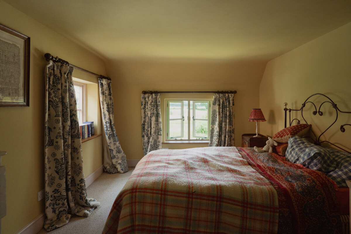 Colorful Interiors and Period Features in a 16th-Century Farmhouse 23 beige-yellow bedroom