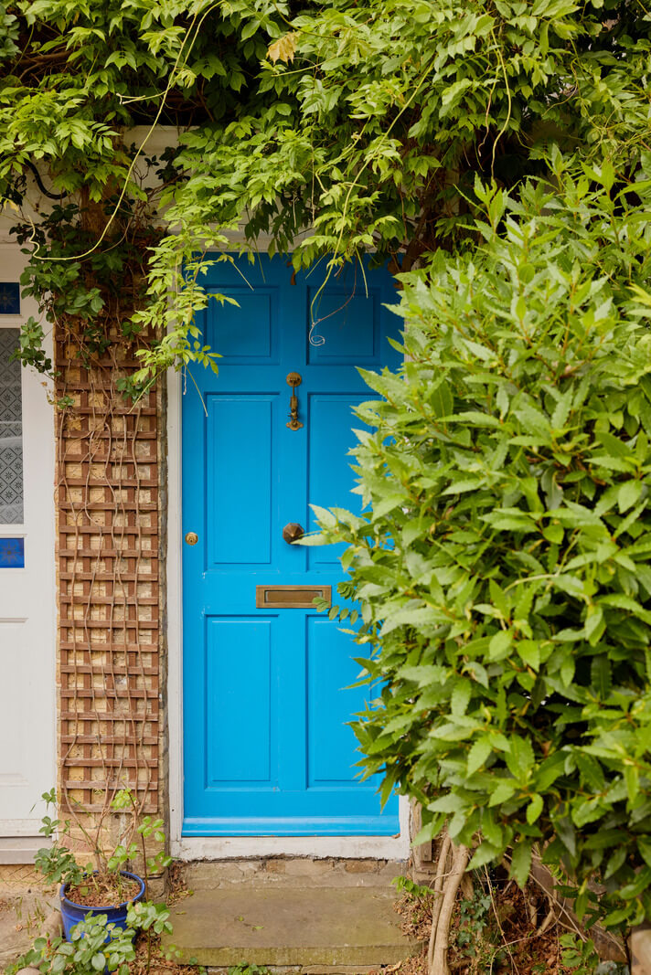 Cozy Living Spaces and Limewash Walls in an Artist's English Home 25 blue front door