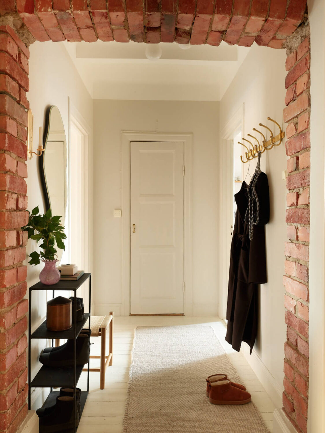 Historic Charm and an Industrial Glass Wall in a Stockholm Apartment 24 brick doorway hall Historic Charm and an Industrial Glass Wall in a Stockholm Apartment