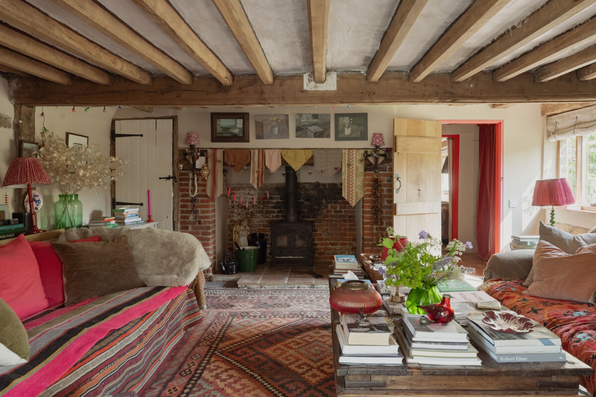 Colorful Interiors and Period Features in a 16th-Century Farmhouse 16 brick fireplace sitting room wooden beams