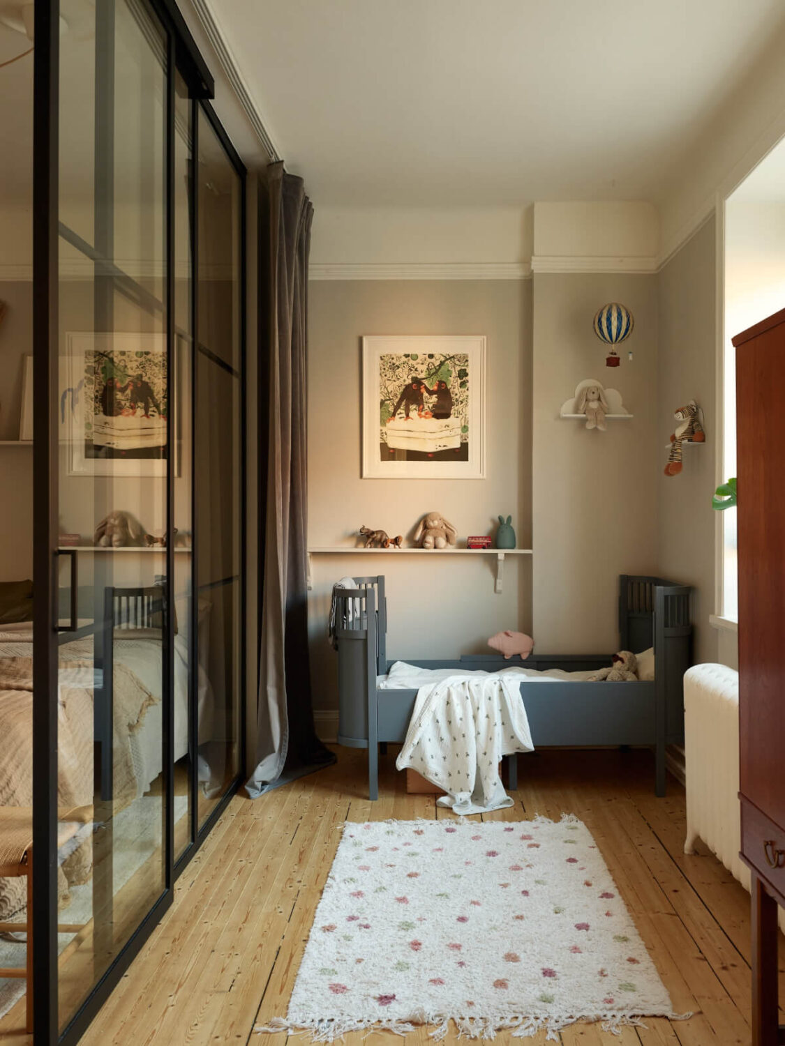 Historic Charm and an Industrial Glass Wall in a Stockholm Apartment 16 childrens room wooden floor light gray walls