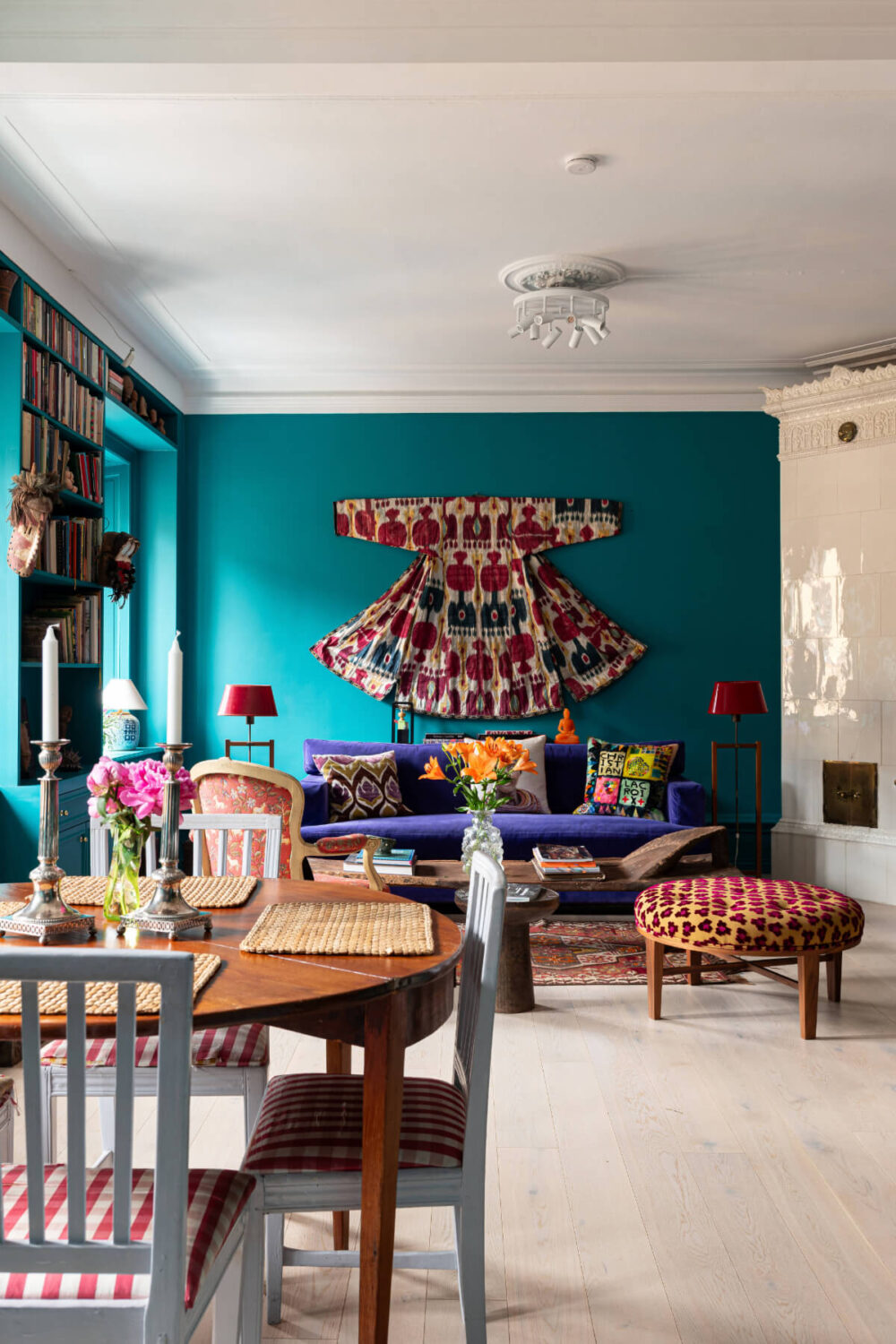 Bold Teal Walls and Antiques in a Turn-of-the-Century Apartment 5 colorful living room built-in bookshelves fireplace teal colored walls