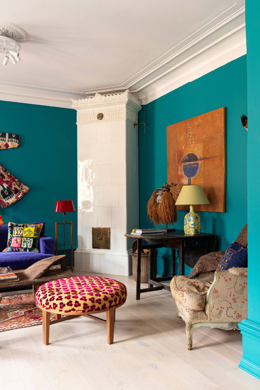 Bold Teal Walls and Antiques in a Turn-of-the-Century Apartment 3 colorful living room swedish fireplace