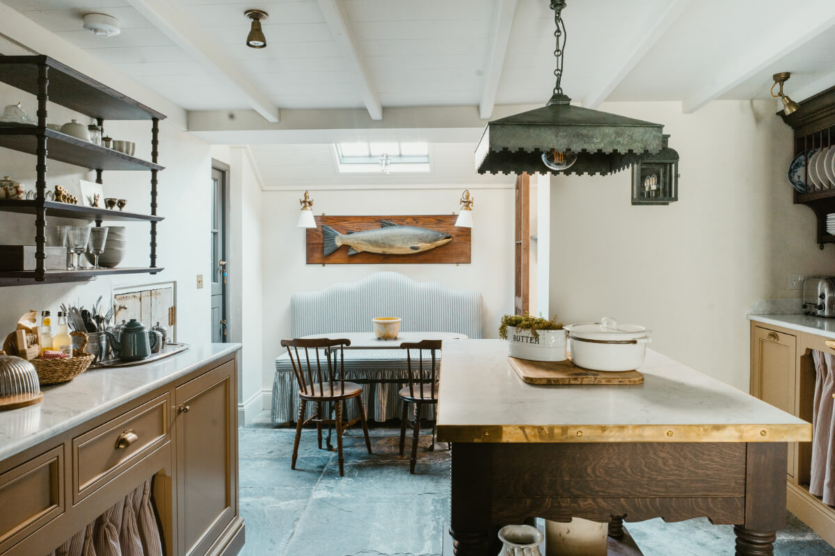 Bespoke Interiors and an Earthy Color Palette in a Historic Cottage 9 cottage kitchen with flagstone floor dining area under skylights