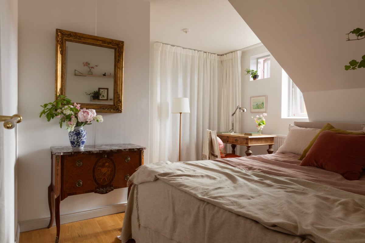 Antiques and Modern Additions in a Cozy Top Floor Duplex Apartment 24 cozy attic bedroom storage behind curtains