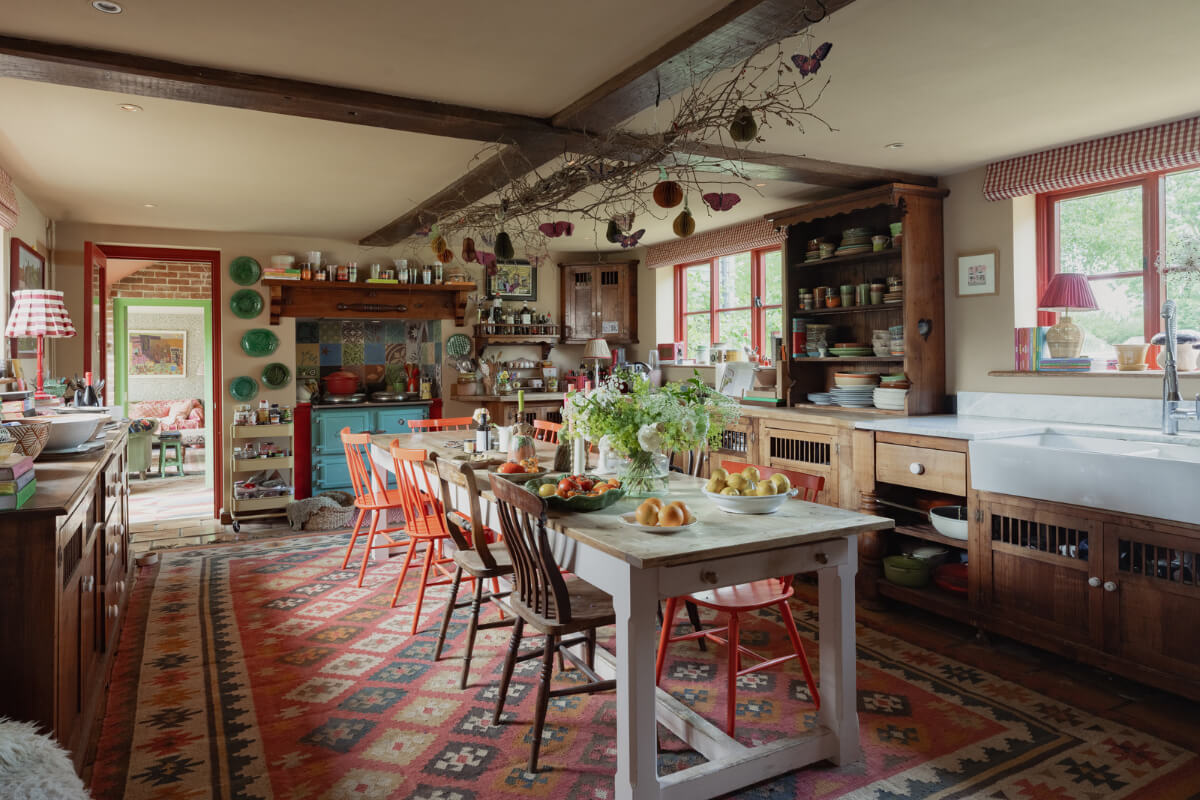 Colorful Interiors and Period Features in a 16th-Century Farmhouse 7 cozy colorful farmhouse style kitchen large wooden table