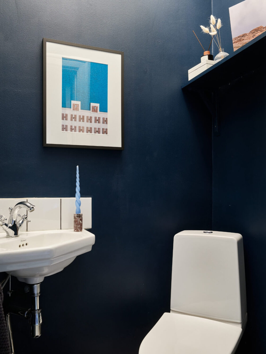 Historic Charm and an Industrial Glass Wall in a Stockholm Apartment 22 dark blue guest toilet