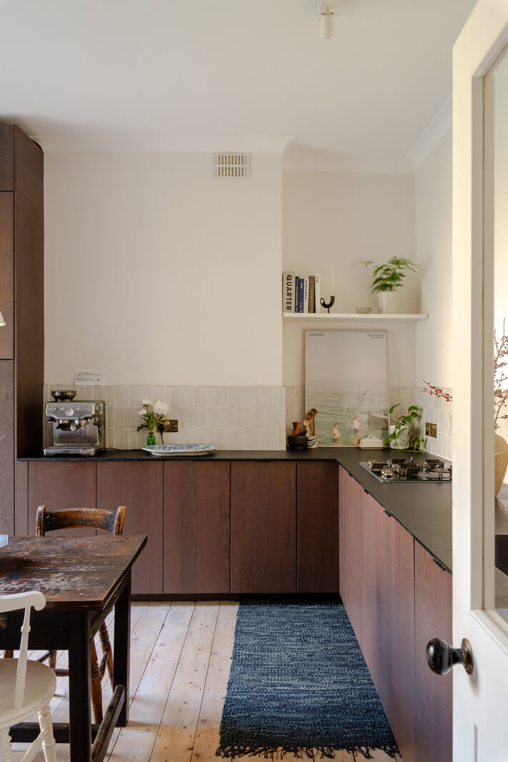A Bright Ground Floor Apartment with a Beautiful Garden 9 dark stained kitchen cabinets black countertop