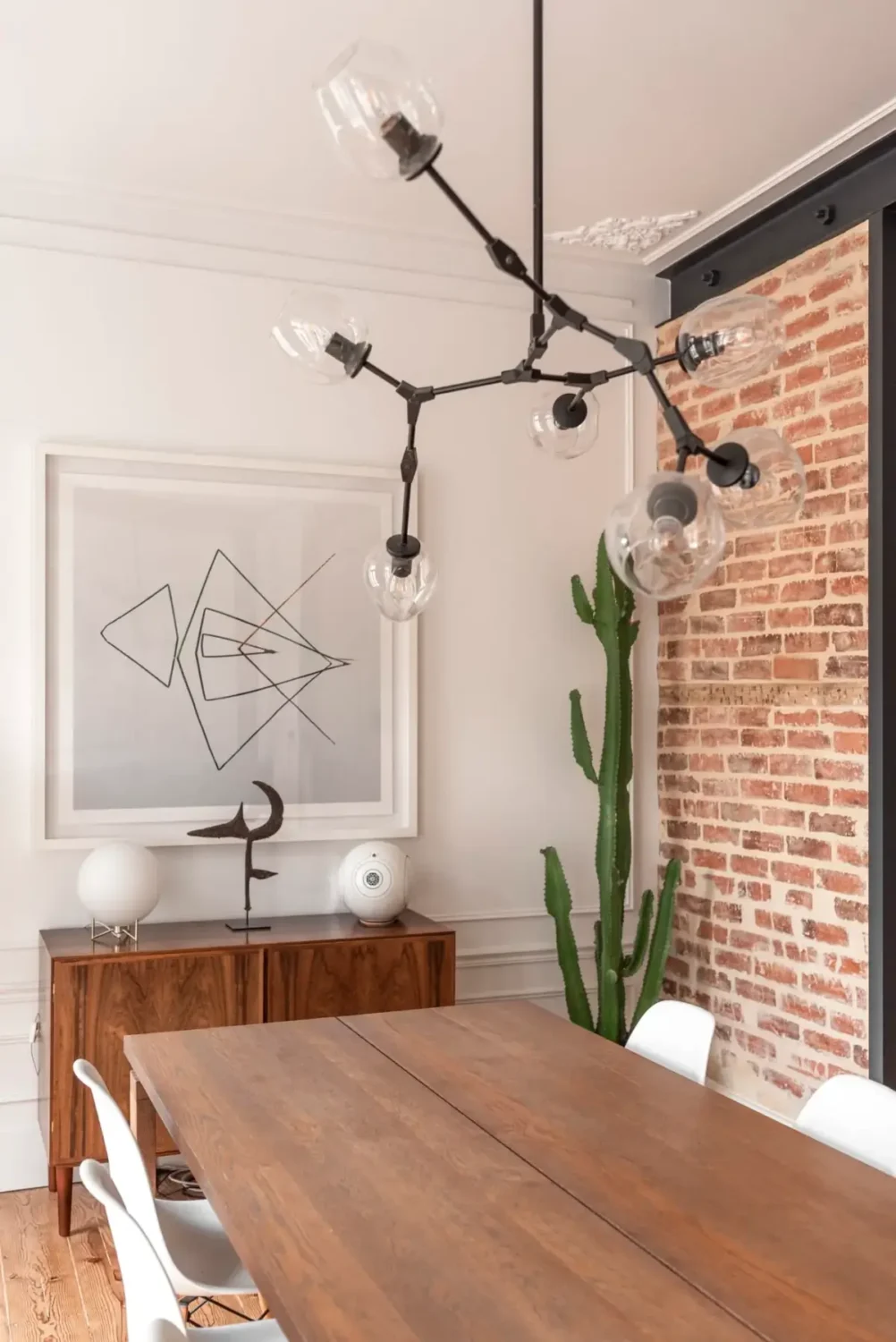 A Light-Filled Duplex Apartment in a Classical Lisbon Building 5 dining room exposed brick wall