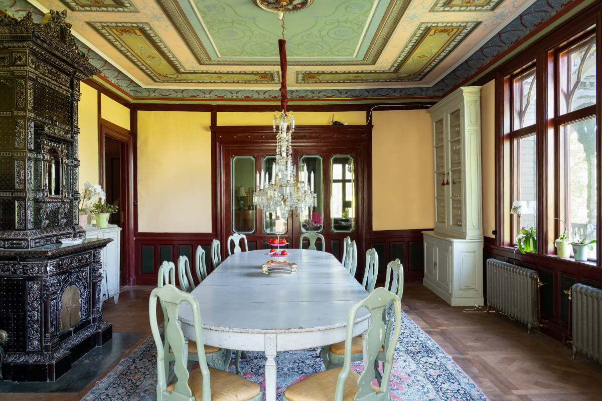 A Grand Historical Swedish Villa with Views of a Royal Castle 2 dining room ornate fireplace