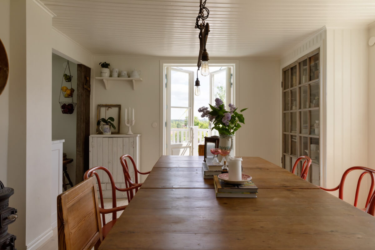 An Idyllic 18th Century Cottage with a Charming Garden 16 dining room wooden table red chairs