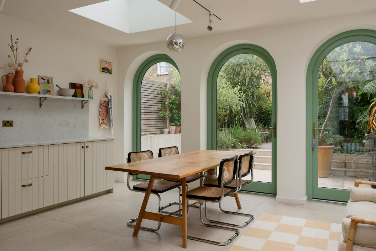 A Victorian Family House with a Tuscan-Inspired Kitchen Extension 11 dining table arched windows