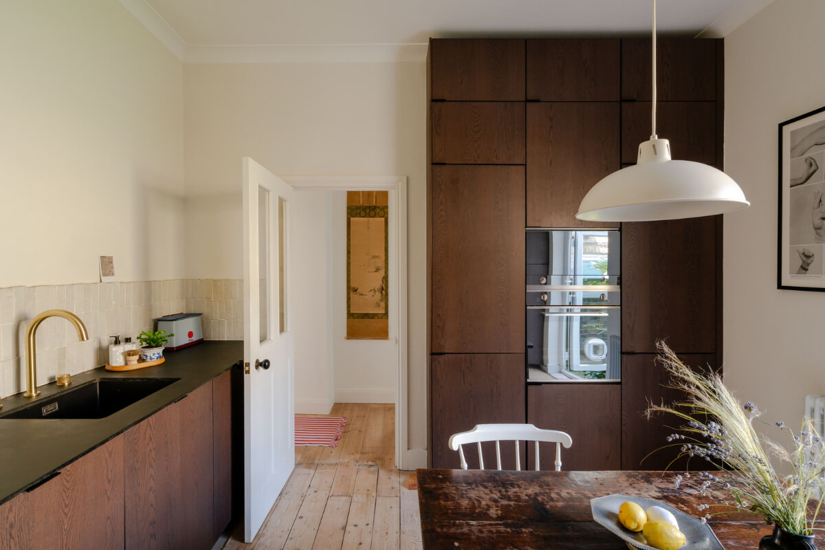 A Bright Ground Floor Apartment with a Beautiful Garden 11 floor to ceiling dark stained kitchen cabinets