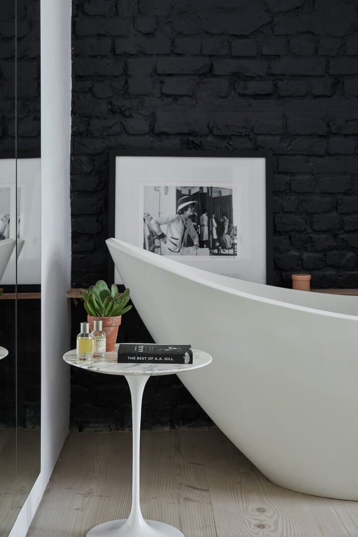A Black and White Primrose Hill Mews House with a Roof Terrace 14 freestanding bath black-painted brick wall