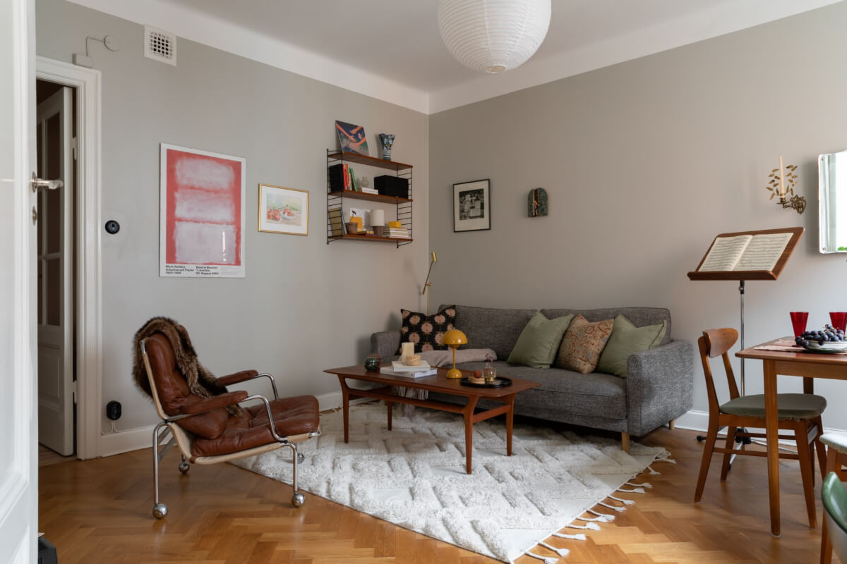 A Nice Color Palette and Original Elements in a Cozy 1930s Apartment 5 gray living room herringbone parquet floor
