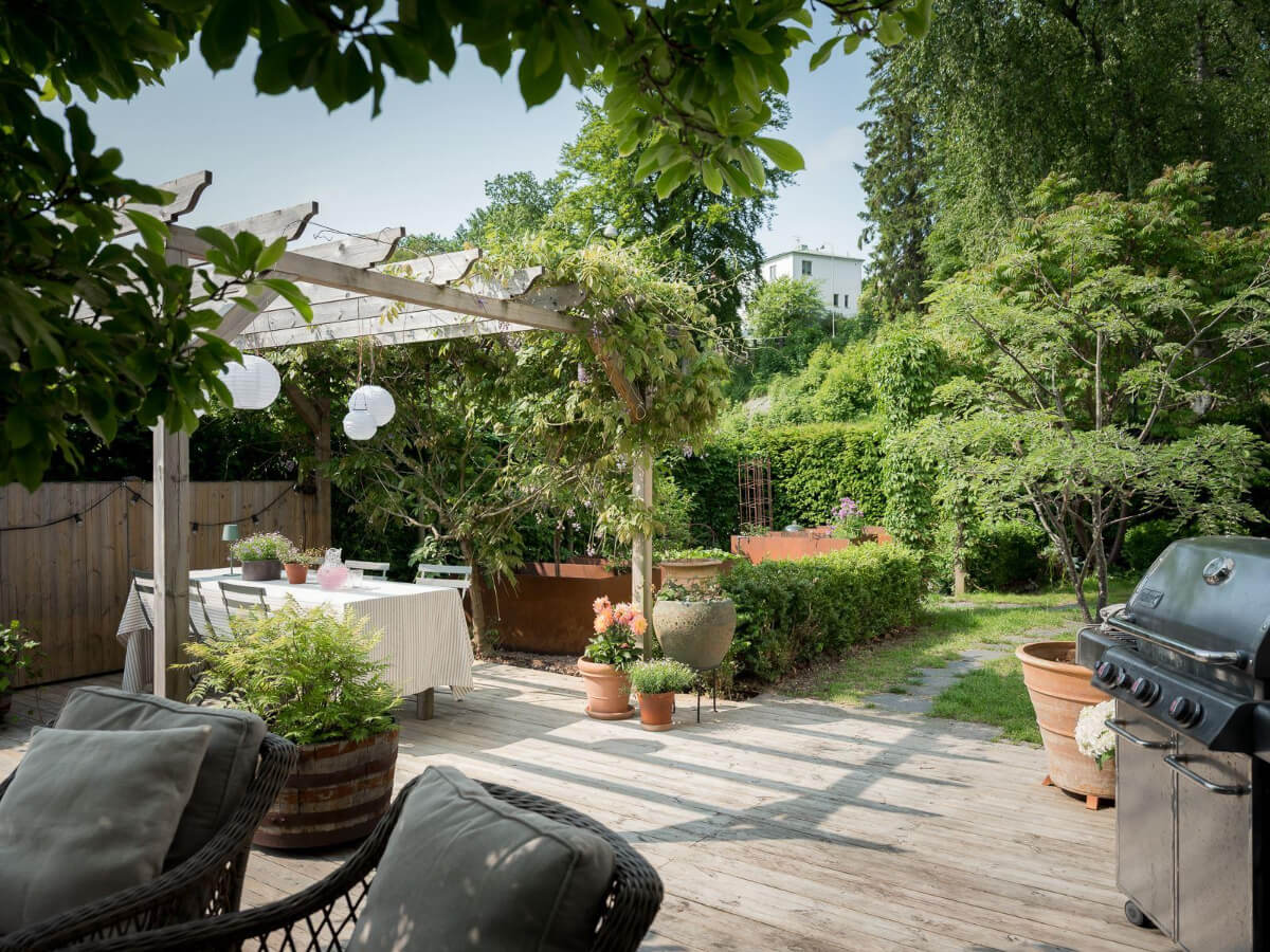 A Floral Painted Ceiling in a 1920s Family Home in Sweden 37 green garden with wooden terrace