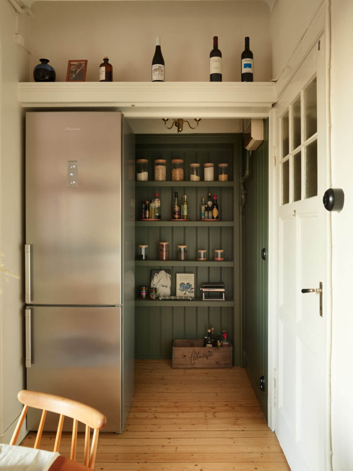 Historic Charm and an Industrial Glass Wall in a Stockholm Apartment 10 green pantry
