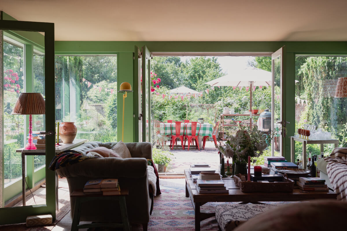 Colorful Interiors and Period Features in a 16th-Century Farmhouse 11 green sitting room large windows and doors to garden