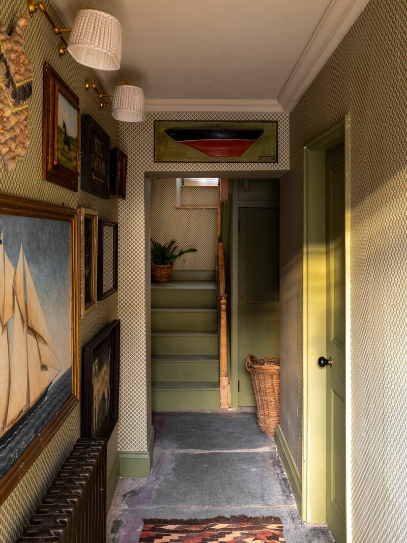 Bespoke Interiors and an Earthy Color Palette in a Historic Cottage 14 hall flagstone floor green patterned wallpaper