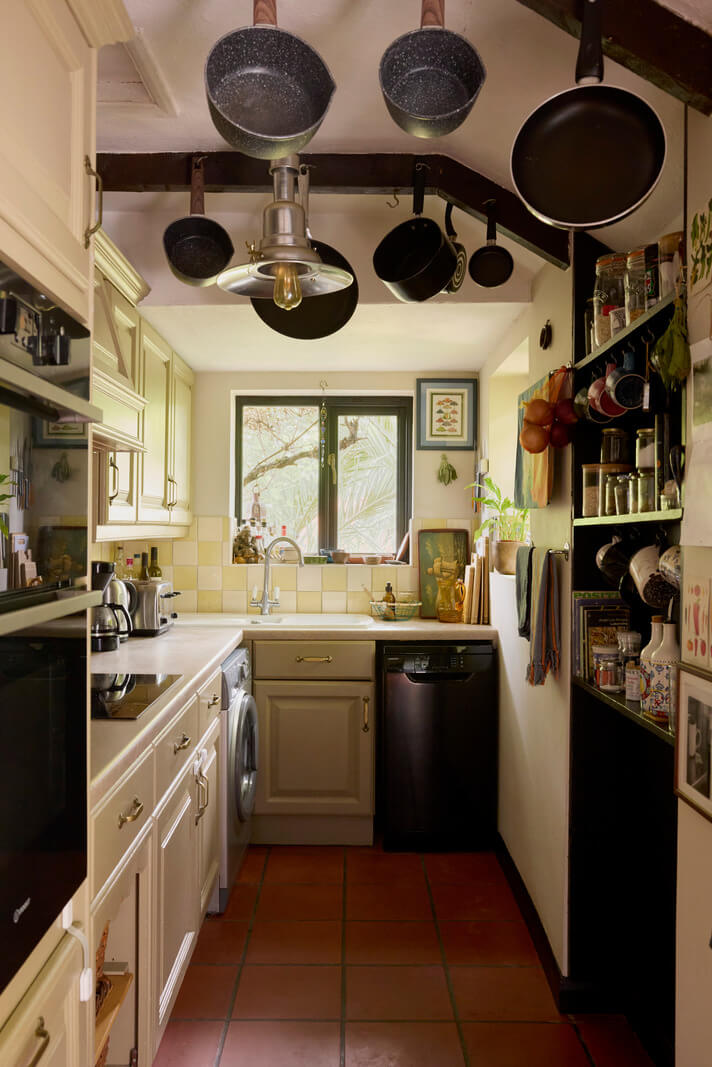 Cozy Living Spaces and Limewash Walls in an Artist's English Home 11 kitchen checkerboard pattern backsplash tiles terracotta floor