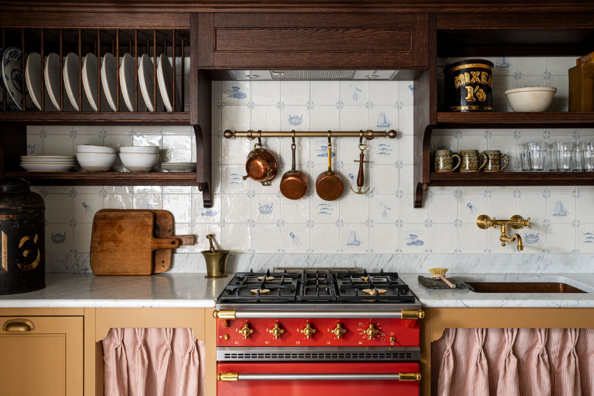 Bespoke Interiors and an Earthy Color Palette in a Historic Cottage 7 kitchen cornish delft-blue backsplash tiles plate rack