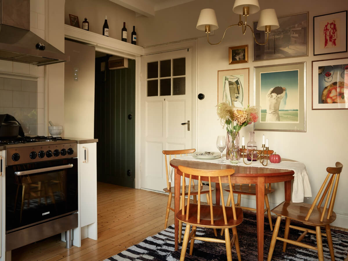 Historic Charm and an Industrial Glass Wall in a Stockholm Apartment 9 kitchen gallery wall round wooden dining table