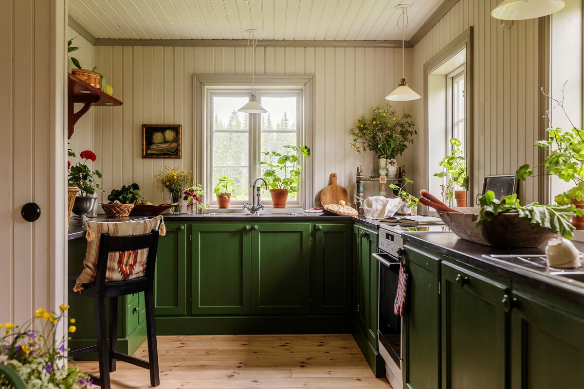 A Beautifully Preserved Historic Country House in Sweden 7 kitchen green cabinets bar seating