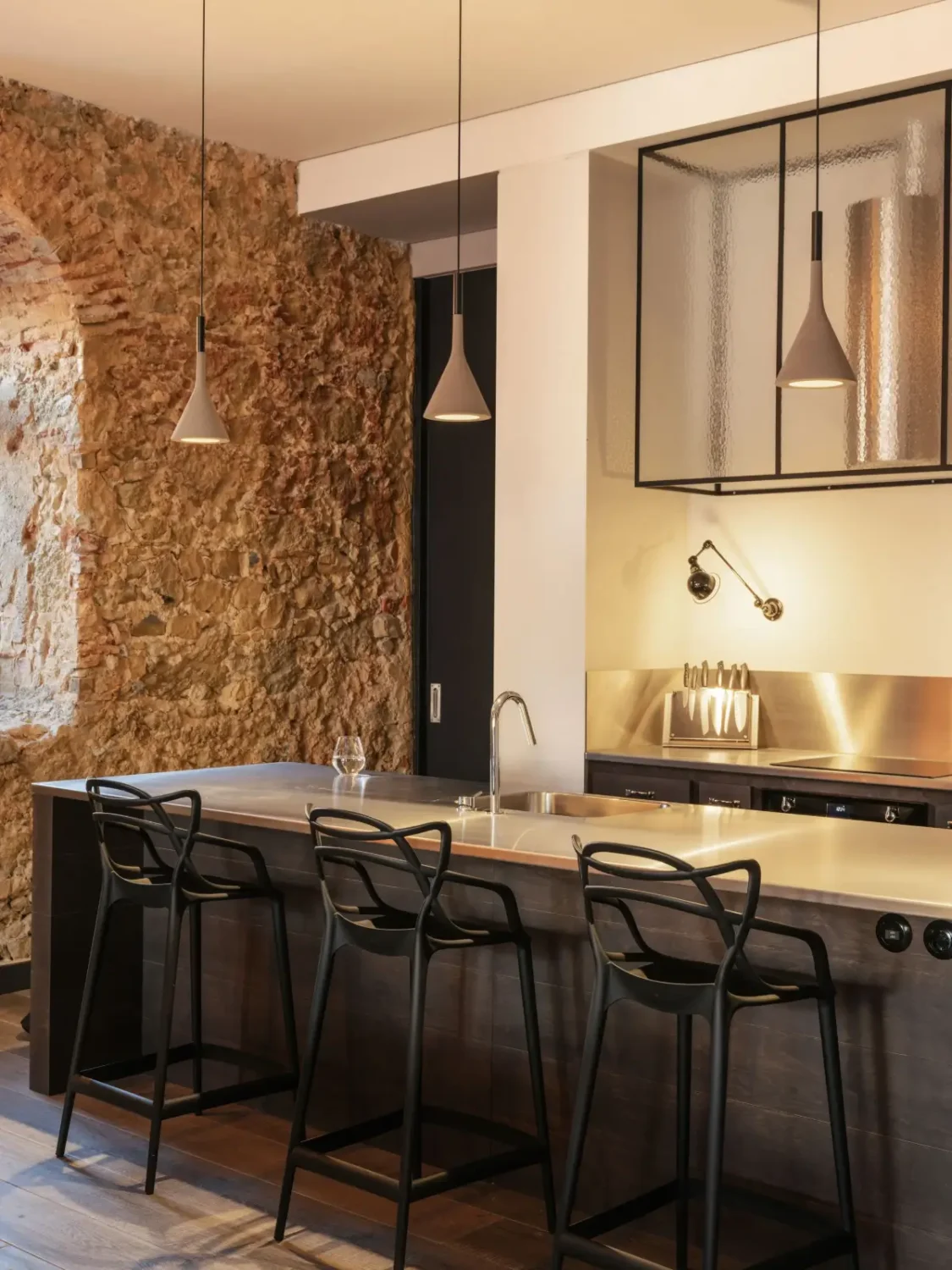 An Eye-Catching Stone Wall in a Beautiful Lisbon Apartment 5 kitchen stainless steel countertop
